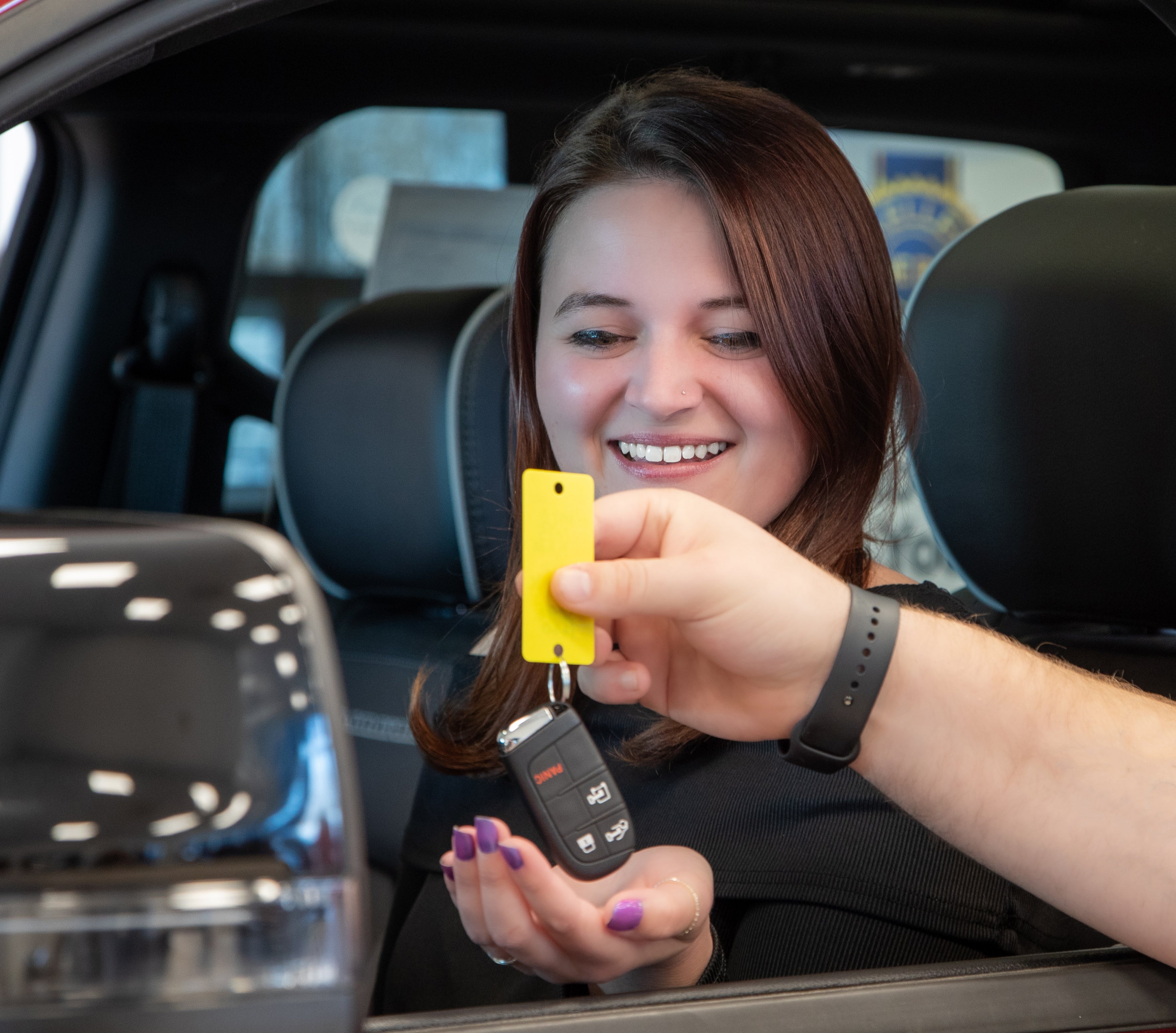 Salesperson showing a vehicle on the showfloor