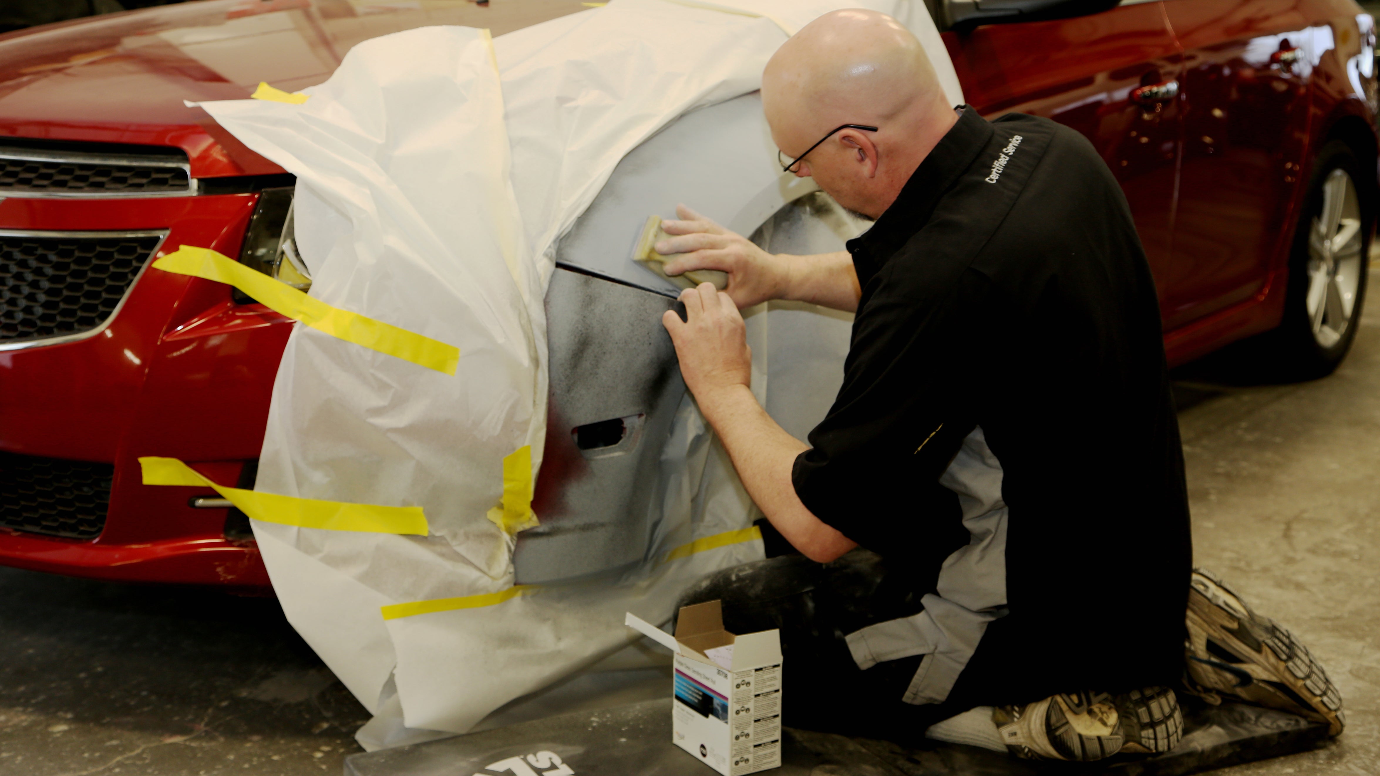 Auto body technician repairing vehicle at Ryan Collision Center